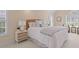 Bright bedroom featuring white bedding, natural furnishings, and bright natural light from the shuttered windows at 1441 Waterside Ct, Mount Pleasant, SC 29464