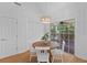 Bright dining area with wood table, white chairs, and sliding glass door to the outside deck at 1441 Waterside Ct, Mount Pleasant, SC 29464