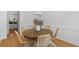 Dining room with wood table, rattan chairs and view into the modern kitchen at 1441 Waterside Ct, Mount Pleasant, SC 29464