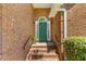 Welcoming front door with brick steps, decorative wreath, sidelights and black railings at 1441 Waterside Ct, Mount Pleasant, SC 29464