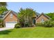 Charming brick home with lush green lawn, mature trees, and a welcoming front entrance at 1441 Waterside Ct, Mount Pleasant, SC 29464