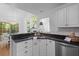 Modern kitchen features dark countertops, white cabinets, and stainless steel appliances at 1441 Waterside Ct, Mount Pleasant, SC 29464