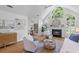 Bright living room featuring vaulted ceilings, a fireplace, hardwood floors, and stylish neutral decor at 1441 Waterside Ct, Mount Pleasant, SC 29464