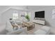 Cozy living room with comfortable white seating, ceiling fan, and natural light at 1441 Waterside Ct, Mount Pleasant, SC 29464
