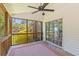 Relaxing screened porch with ceiling fan and view of lush backyard landscaping at 1441 Waterside Ct, Mount Pleasant, SC 29464