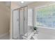 Shower with glass door near jacuzzi and a window with block glass at 1441 Waterside Ct, Mount Pleasant, SC 29464