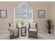 Sitting area by a window with shutter shades, featuring two wicker chairs and neutral colors at 1441 Waterside Ct, Mount Pleasant, SC 29464