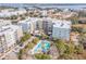 Aerial view of complex featuring multiple buildings, a pool, and surrounding waterway, showcasing premier community features at 145 Pier View St # 111, Charleston, SC 29492