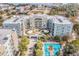 Aerial view of condo complex, featuring a pool, landscaping, and scenic waterfront views at 145 Pier View St # 111, Charleston, SC 29492