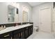 The bathroom features dual sinks with modern fixtures and vanity lights at 145 Pier View St # 111, Charleston, SC 29492