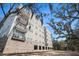 Luxury apartment building exterior showcasing modern design, multiple stories, balconies, and mature trees at 145 Pier View St # 111, Charleston, SC 29492