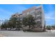 Beautiful brick apartment building showcasing multiple balconies and manicured landscaping at 145 Pier View St # 111, Charleston, SC 29492