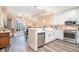 Bright, open kitchen featuring modern appliances, stainless steel fixtures, and hardwood floors at 145 Pier View St # 111, Charleston, SC 29492