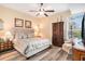 Warm main bedroom featuring a ceiling fan and closet with natural light at 145 Pier View St # 111, Charleston, SC 29492