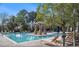 Community pool surrounded by lounge chairs and lush landscaping, perfect for relaxation and recreation at 145 Pier View St # 111, Charleston, SC 29492