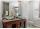 Bathroom featuring a double vanity with vessel sinks and granite countertop at 150 Bee St # 308, Charleston, SC 29401