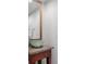 Bathroom features a modern glass bowl sink atop granite countertop with stylish wood vanity and decorative mirror at 150 Bee St # 308, Charleston, SC 29401