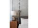 Modern bedroom featuring a concrete wall and a nightstand with lamp at 150 Bee St # 308, Charleston, SC 29401