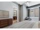 Light-filled bedroom showcases an open bathroom and stylish seating area by the window at 150 Bee St # 308, Charleston, SC 29401