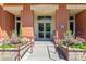 Inviting building entrance with colorful flowers and brick planters, showcasing an accessible ramp at 150 Bee St # 308, Charleston, SC 29401