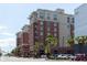 Attractive building exterior with palm trees and well-maintained landscaping in a vibrant neighborhood at 150 Bee St # 308, Charleston, SC 29401