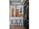 Open-concept kitchen with bar stools and a modern stainless steel vent hood at 150 Bee St # 308, Charleston, SC 29401