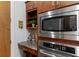 Kitchen with stainless steel microwave and oven, granite countertops, and wooden cabinets at 150 Bee St # 308, Charleston, SC 29401