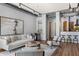 Bright living room with open concept with view to a modern kitchen and features exposed ductwork at 150 Bee St # 308, Charleston, SC 29401