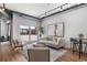 Bright living room with modern design, exposed ductwork, and an outdoor patio view through large glass sliding doors at 150 Bee St # 308, Charleston, SC 29401
