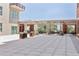 Open-air patio space with elegant pavers, seating, and planters, creating an inviting outdoor living area at 150 Bee St # 308, Charleston, SC 29401