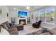 Cozy living room features a fireplace, plush seating, and plenty of natural light, creating an inviting atmosphere at 1541 Homecoming Blvd, Ravenel, SC 29470