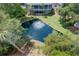 Stunning aerial view of a home with a large pool and lush greenery, offering a private oasis at 1551 Ben Sawyer Blvd # 4D, Mount Pleasant, SC 29464