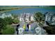 Multi-level home featuring covered balconies, complemented by mature palm trees, and situated near a tranquil body of water at 1551 Ben Sawyer Blvd # 4D, Mount Pleasant, SC 29464