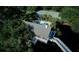 Aerial view showcasing pool, tennis court, and covered structure over water in a lush green community at 1551 Ben Sawyer Blvd # 4D, Mount Pleasant, SC 29464