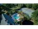 This aerial view showcases a sparkling pool, tennis court, and lush greenery in a desirable community at 1551 Ben Sawyer Blvd # 4D, Mount Pleasant, SC 29464