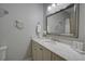 Bathroom with a large mirror, vanity with marble countertop, white cabinets and wall decor at 1551 Ben Sawyer Blvd # 4D, Mount Pleasant, SC 29464