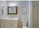 Bathroom featuring a marble vanity, framed mirror, and a shower with white tiling at 1551 Ben Sawyer Blvd # 4D, Mount Pleasant, SC 29464