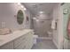 Elegant bathroom with double vanity, granite counters, tiled shower with glass enclosure, and modern lighting at 1551 Ben Sawyer Blvd # 4D, Mount Pleasant, SC 29464