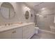 Stylish bathroom features double sinks, granite counters, tiled shower with bench, and sleek fixtures at 1551 Ben Sawyer Blvd # 4D, Mount Pleasant, SC 29464