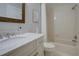 Bright bathroom featuring a marble vanity, framed mirror, and tub with tiled shower at 1551 Ben Sawyer Blvd # 4D, Mount Pleasant, SC 29464