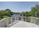 Wooden deck with white railing overlooking trees and homes at 1551 Ben Sawyer Blvd # 4D, Mount Pleasant, SC 29464
