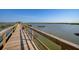 Scenic view of a wooden walkway extending over water to a gazebo with lush vegetation at 1551 Ben Sawyer Blvd # 4D, Mount Pleasant, SC 29464