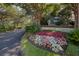 The landscaped entrance to Simmons Pointe is lush and inviting, with mature trees at 1551 Ben Sawyer Blvd # 4D, Mount Pleasant, SC 29464