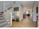 Welcoming foyer features wood flooring, white staircase, and views to the living areas at 1551 Ben Sawyer Blvd # 4D, Mount Pleasant, SC 29464