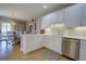 Bright kitchen with white cabinets, stainless steel appliances, and a view into the dining area at 1551 Ben Sawyer Blvd # 4D, Mount Pleasant, SC 29464