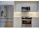 Modern kitchen with stainless steel refrigerator, microwave, range and white cabinets at 1551 Ben Sawyer Blvd # 4D, Mount Pleasant, SC 29464