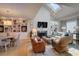 Open-concept living room with built-in bookshelves, a fireplace, and a vaulted ceiling with skylight at 1551 Ben Sawyer Blvd # 4D, Mount Pleasant, SC 29464