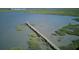Scenic aerial view of a long pier leading to a gazebo, extending over the marsh at 1551 Ben Sawyer Blvd # 4D, Mount Pleasant, SC 29464