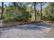 Guest parking area with wooden dividers surrounded by trees and gravel at 1551 Ben Sawyer Blvd # 4D, Mount Pleasant, SC 29464