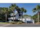 Community pool house surrounded by palm trees and picturesque water feature at 1551 Ben Sawyer Blvd # 4D, Mount Pleasant, SC 29464